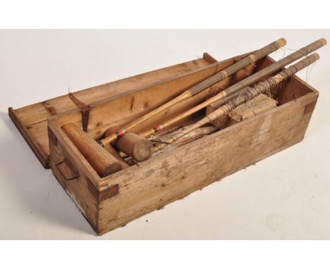 A vintage 20th century croquet set comprising of mallets, pegs and Excelite composite croquet balls. The croquet set comes in