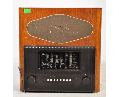 A retro vintage 1940s mid 20th century Murphy A92 oak cased station master radio. The speaker mesh appearing with small tears