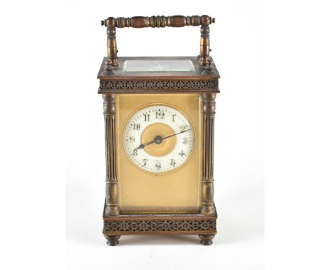 An early 20th century brass cased carriage clock. The face having reeded columns with fret borders and perpendicular handle t