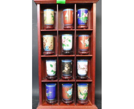 A collection of twelve 20th century Chinese cloisonne enamelled tea caddy storage jars complete with Chinese hardwood stands.