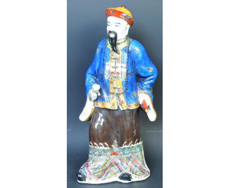 A large early 20th century circa. 1920's Chinese hand painted ceramic figure to depict an elder in traditional dress holding 