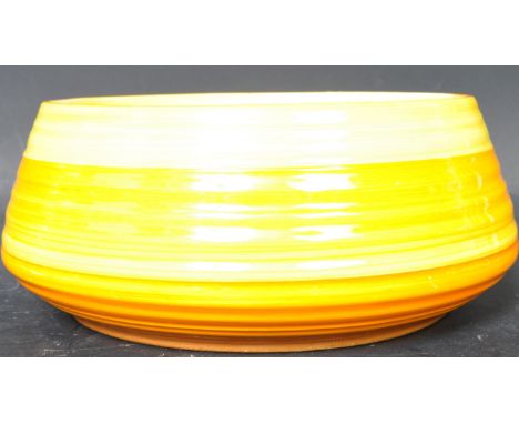 A vintage 20th Century Art Deco hand painted ceramic table fruit bowl having a ribbed body with orange and yellow painted ban