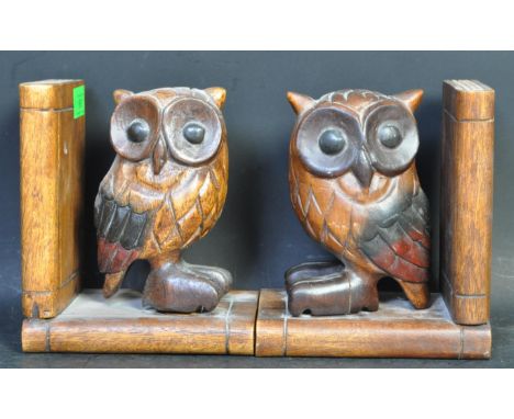 A pair of vintage hand carved hardwood owl book ends. The Tawny owl standing on a book with another to the back. Measures app
