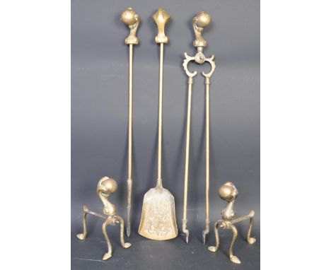 A vintage 20th century brass fireside set, the handle of each piece being in the form of a griffin foot holding an orb. The s