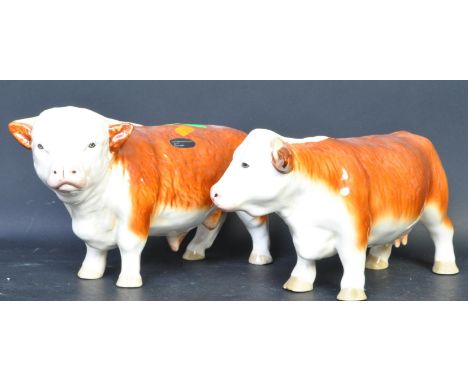 A pair of vintage 20th century Coopercraft Hereford china bull and cow figures. Marked Made in England to the base. Measuring