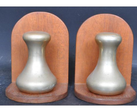 A pair of mid 20th century retro book ends having 4lb metal scale weights mounted upon wooden bases. Measures 16cm tall.&nbsp