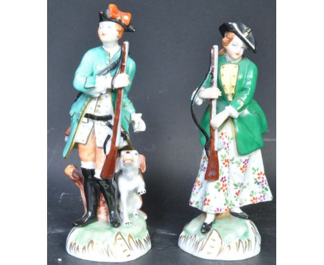 A pair of Victorian early 20th century German Dresden porcelain hunting figurines of a lady and a man. The lot to include a c