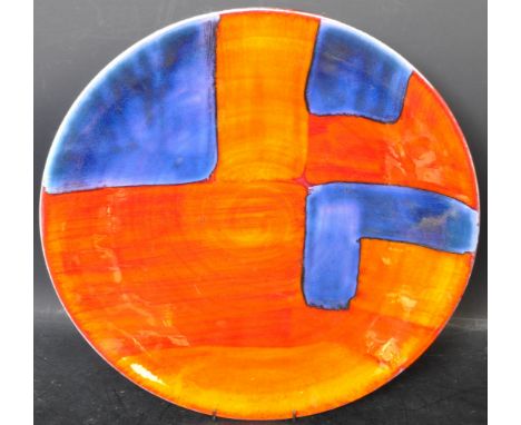 A large 20th Century ceramic hand painted charger plate having abstract blue and orange decoration with a luster glazed finis