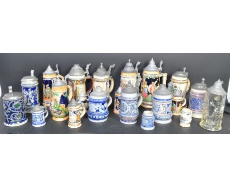 A large collection of vintage 20th century German stein ceramic and metal tankards of various sizes. The lot to include stein