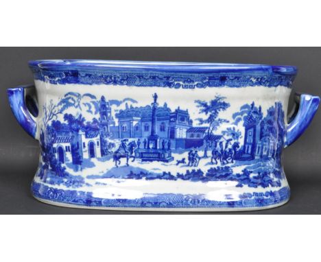 A 20th century Victorian ceramic blue and white foot bath of oval form with carry handles to the side. The foot bath having a