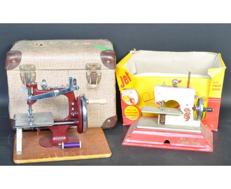 Two vintage retro mid 20th Century toy sewing machines. The lot to include a Little Betty Jet Sewing machine having a red tin