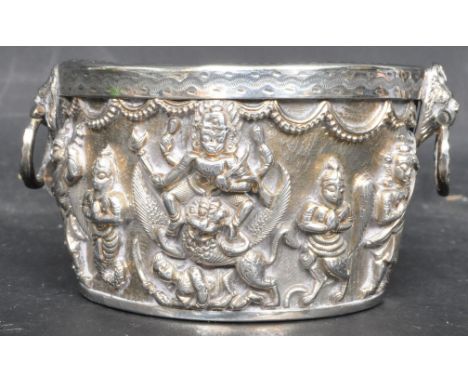 A vintage 20th century Indian / South Asian white metal bowl having raised decoration of Hindu deities and lions head carry h