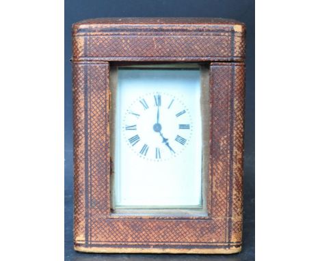 An early 20th Century French brass carriage clock. The clock having a double arched swing handle with&nbsp;ceramic dial with 