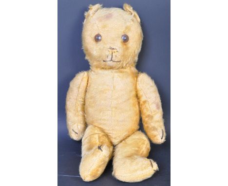 A mid 20th century 1950's Chad Valley style jointed mohair teddy bear with amber glass eyes and stitched paws. Measures 52cm 