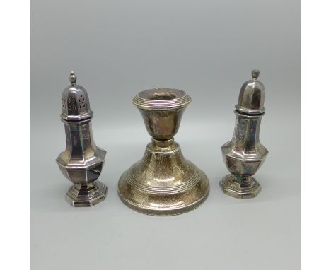 A silver salt and pepper pair, 85g, and a silver candlestick 
