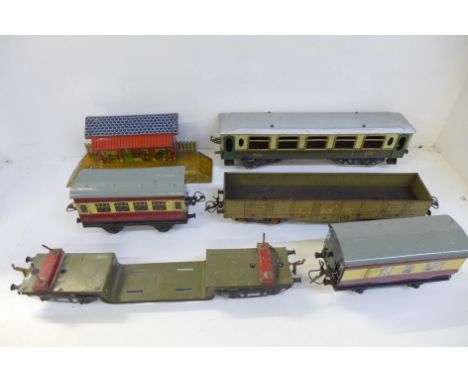 A collection of Hornby O gauge model rail, carriages, wagons, track 