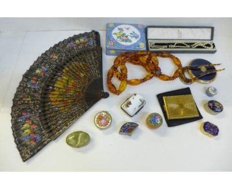 Compacts, an enamel box, a string of amber coloured beads, etc. 