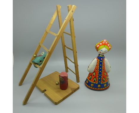 A clockwork Russian doll (no key) and a vintage wooden toy 