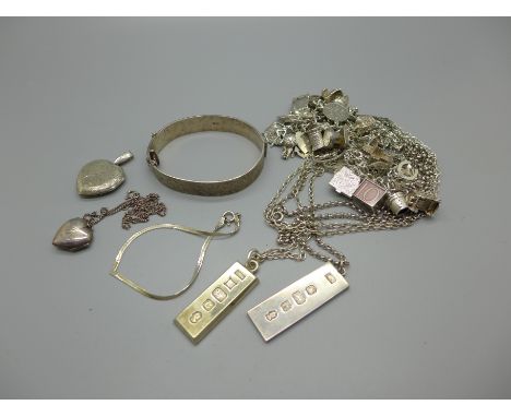 Silver jewellery including a charm bracelet, two ingot pendants and a bangle, total weight 231g, (charm bracelet 100g) 