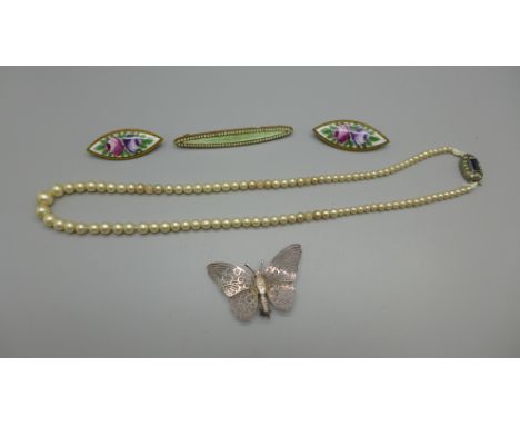 Two enamelled brooches with floral design, another enamel bar brooch, a silver butterfly brooch and a faux pearl necklace wit