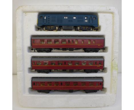 A Jouef OO gauge model locomotive and three carriages 