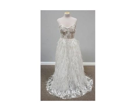 An unworn full-length gown with silvered leaf design embellished with pearls and feathers, boned bodice, approx. size 6/8, 14