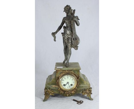 A 19th century French mantel clock with green onyx case and gilt-metal mounts, surmounted with a spelter figure of a classica