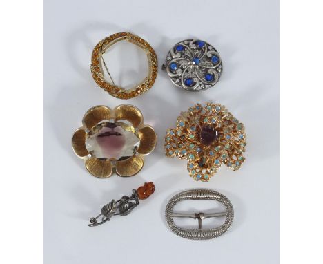 Six various brooches including Christian Dior, Exquisite, a silver coloured celtic style brooch with blue coloured stones and