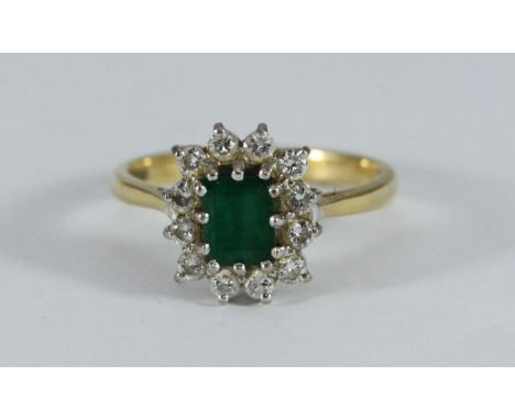 An 18ct gold, emerald and diamond ring, emerald cut 6.11x4.86mm, estimated diamond weight, 0.24pts, 4.16g 