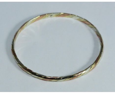 A 9ct tri-colour gold bangle, 17.49g, in retail box 