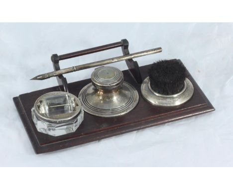 A George V wooden ink stand with silver-mounted nib wipe, capstan inkwell, stamp wetter-roller and associated pen, Birmingham