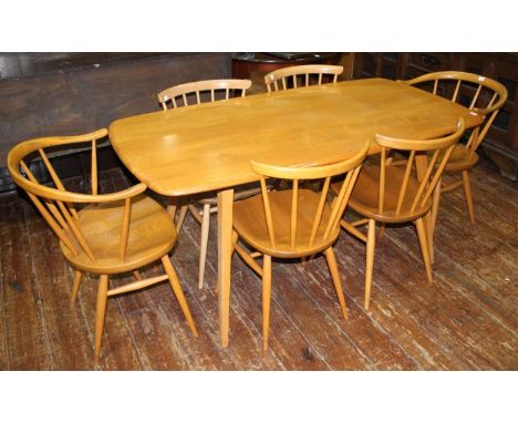 An Ercol light elm dining table of rectangular form, raised on squared, tapering supports, 150 x 77cm, together with a set of