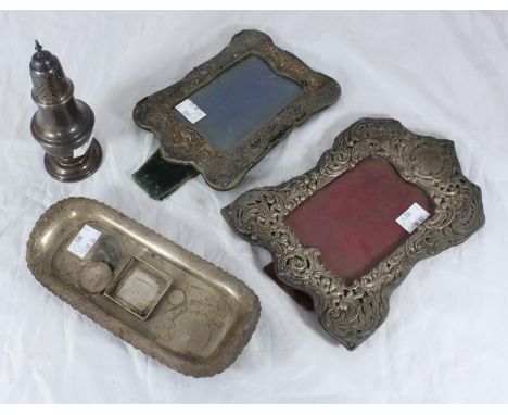 A silver sugar caster of baluster form, together with a silver ink stand, (lacking inkwell) and two silver-mounted easel phot