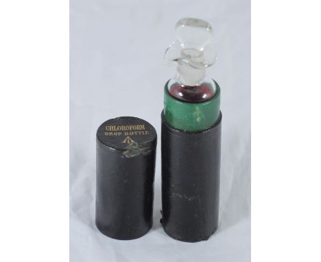An Admiralty pattern Chloroform drop bottle and stopper, housed in two-piece black leather covered tube, the top with embosse