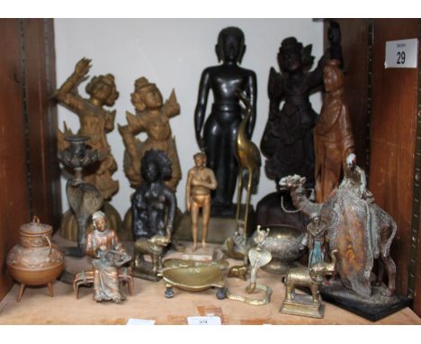 SECTION 29. A quantity of wooden carved Balinese style figures, together with some Oriental brass and copper figures, candles
