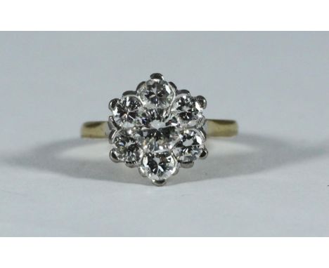 18ct Yellow Gold and Platinum Diamond Daisy-cluster ring, centrally set with a round brilliant cut Diamond spreading approxim