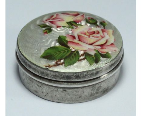 An Edwardian circular silver pill box by Lawrence Emanuel, the removable lid with enamelled flowers to a silver guilloche ena