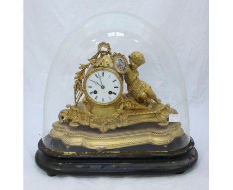 A 19th century gilt-spelter figural mantel clock modelled with a putto holding a porcelain plaque of a cherub, eight-day Fren