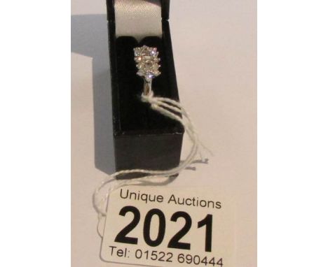 A diamond cluster ring set with baguette cut diamonds and round cuts in white gold, half carat weight. size K.