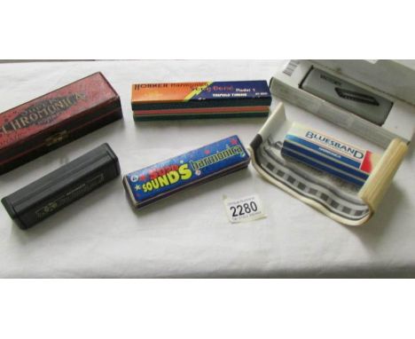 5 harmonica's including Hohner and an empty Hohner harmonica box.