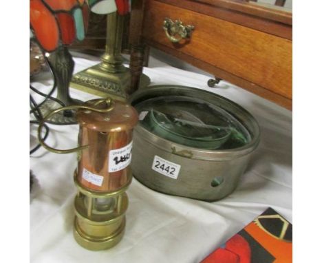 A world war 2 map magnifying glass and a small brass &amp; copper miner's lamp.