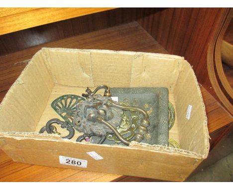 A small box of lions head brass door knocker, handles etc.
