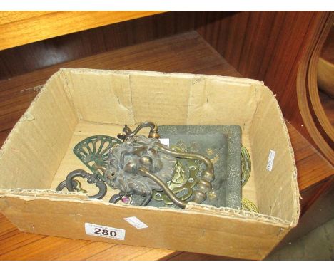 A small box of lions head brass door knocker, handles etc.