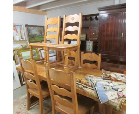 A heavy light oak dining table and 6 chairs.