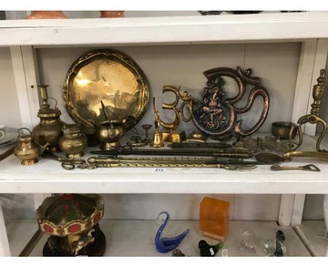 A shelf of brass items etc.