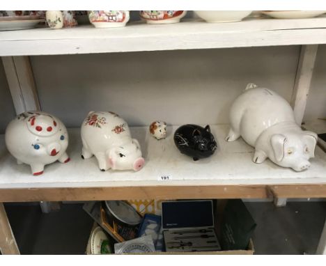 A shelf of piggy banks/money banks