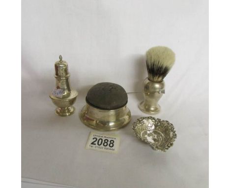 A silver pin cushion trinket box, a silver shaving brush, a silver pepper pot and a silver trinket dish.