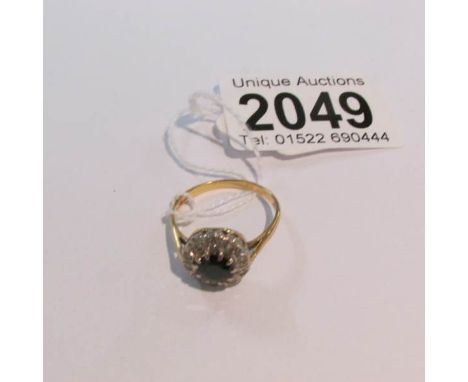 An 18ct gold ring set diamonds and central sapphire, size R. Approximate gross weight 4 grams.