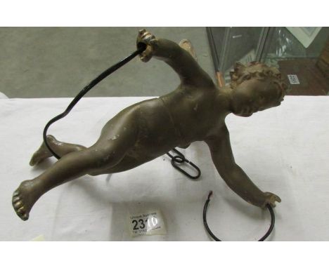 A hanging ceiling light in the form of a cherub (needs re-wiring).