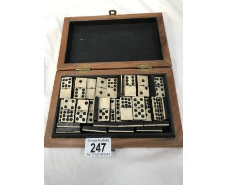 A set of dominoes in box. Tile up to 9 dots.